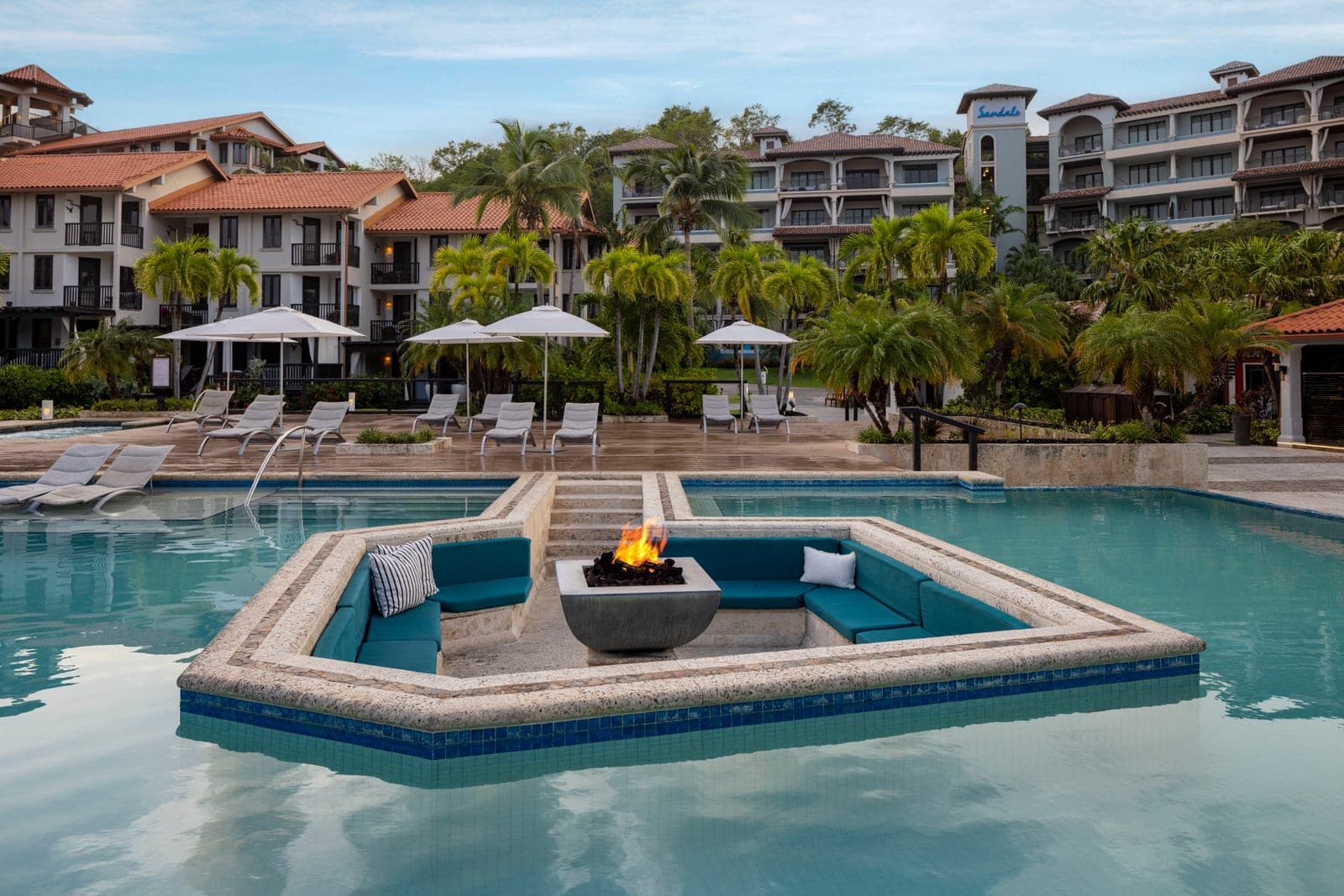 Pink Gin Village pool with sunken lounge and firepit at Sandals Grenada